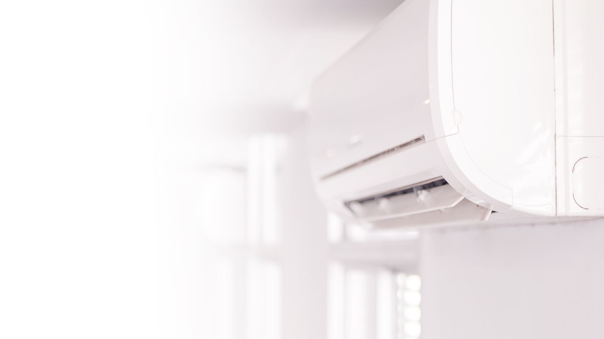 Wall-mounted ductless air conditioner is installed in a room of a residential house in Grants Pass.
