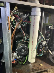 Technician repairing furnace collector box components in Grants Pass, OR