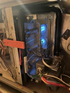 Technician servicing furnace gas valve components in Grants Pass, OR.