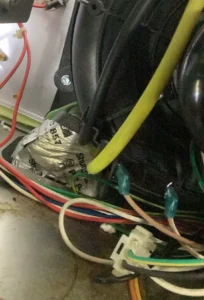 Technician servicing furnace inducer draft motor components in Grants Pass, OR.