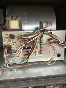 Technician repairing furnace inducer motor and pressure switch components in Grants Pass, OR.