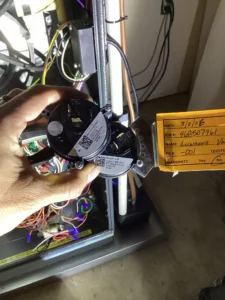 Technician replacing a furnace pressure switch during heating repair in Grants Pass, OR.