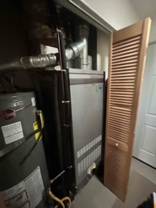 Technician servicing a furnace ignitor during heating repair in Medford, OR