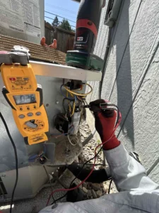 Grants Pass AC repair technician diagnosing an air conditioner that was buzzing and tripping the breaker