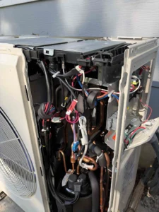 Grants Pass HVAC repair technician replacing a failed component affecting cooling performance