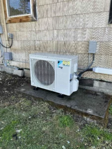Grants Pass AC repair technician diagnosing airflow issues after one room was not cooling evenly